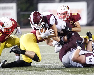 Boardman's Joe Ieraci gets tackled by Cardinal Mooney during their game at Stambaugh Stadium on Friday. EMILY MATTHEWS | THE VINDICATOR