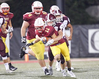 Cardinal Mooney's Mike Scavina gets tackled by Boardman's Zach Hillard during their game at Stambaugh Stadium on Friday. EMILY MATTHEWS | THE VINDICATOR