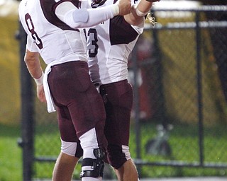 Boardman's Mike O'Horo (8) and Kareem Hamdan celebrate after Hamdan scores a touchdown to take the lead against Cardinal Mooney during the first half of their game at Stambaugh Stadium on Friday. EMILY MATTHEWS | THE VINDICATOR