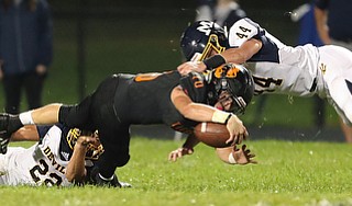 NEW MIDDLETOWN SPRINGFIELD, OHIO - September 21, 2018: MCDONALD BLUE DEILS vs SPRINGFIIELD TIGERS at Tigers Stadium-  New Middletown Springfield Tigers' Garrett Walker (10) streches for extra yardage as McDonald Blue Devils' Jack Bucan (22) and Zach Gray (44) make the tackle during the 1st qtr.  MICHAEL G. TAYLOR | THE VINDICATOR