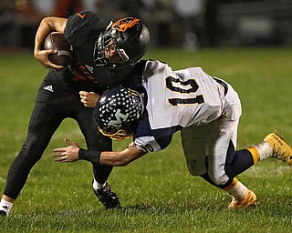 NEW MIDDLETOWN SPRINGFIELD, OHIO - September 21, 2018: MCDONALD BLUE DEILS vs SPRINGFIIELD TIGERS at Tigers Stadium-  New Middletown Springfield Tigers' Mitchell Seymour (7) is tackle by McDonald Blue Devils' Josh Celli (10) during the 1st qtr.  MICHAEL G. TAYLOR | THE VINDICATOR