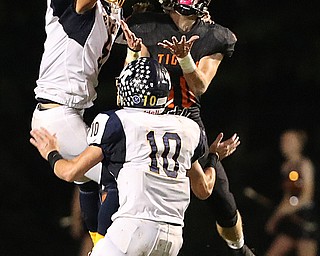 NEW MIDDLETOWN SPRINGFIELD, OHIO - September 21, 2018: MCDONALD BLUE DEILS vs SPRINGFIIELD TIGERS at Tigers Stadium- McDonald Blue Devils' Dominic Schadi (5) and Josh Celli (10) defend against New Middletown Springfield Tigers' Garrett Walker (10)  during the 2nd qtr. Ball was intercepted byMcDonald Blue Devils' Dominic Schadi (5).  MICHAEL G. TAYLOR | THE VINDICATOR