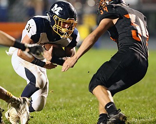 NEW MIDDLETOWN SPRINGFIELD, OHIO - September 21, 2018: MCDONALD BLUE DEILS vs SPRINGFIIELD TIGERS at Tigers Stadium-  McDonald Blue Devils' Alex Cintron (31) is met in the hole by New Middletown Springfield Tigers' David Duvall (34)  during the 2nd qtr.  MICHAEL G. TAYLOR | THE VINDICATOR