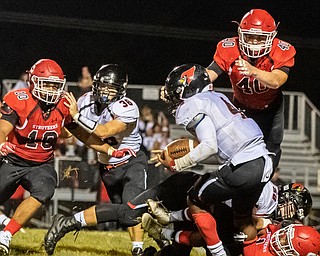 DIANNA OATRIDGE | THE VINDICATOR Canfield's Mehlyn Clinkscale (4), is pressured by Struthers' defenders as he runs the ball during their game at Laddie J. Fedor Field in Struthers on Friday night.