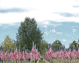 Balloons are released as part of the closing ceremonies for the traveling flag memorial on Sunday. EMILY MATTHEWS | THE VINDICATOR