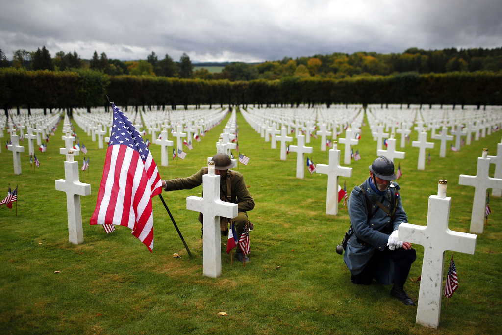 Men in WWI military uniforms pose in the Meuse-Argonne cemetery, northeastern France, during a remembrance ceremony, Sunday, Sept. 23, 2018. A remembrance ceremony is taking place Sunday for the 1918 Meuse-Argonne offensive, America's deadliest battle ever that cost 26,000 lives but helped bringing an end to World War I.