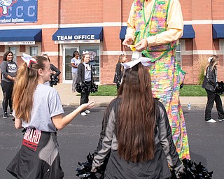 DIANNA OATRIDGE | THE VINDICATOR Harold Stein, better known as Harold the Stiltwalker, passes out smiley face stickers to the Girard High School cheerleaders, who volunteered at the Down Syndrome Association's Buddy Walk of the Valley held at Eastwood Field in Niles on Sunday.