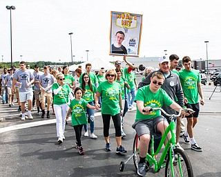 DIANNA OATRIDGE | THE VINDICATOR Noah O'Hara, a freshman at Girard High School, leads his team, Noah's Net, on his bicycle at the Down Syndrome Association's Buddy Walk of the Valley at Eastwood Field in Niles on Sunday. Among his supporters are Girard High School students and the Westminster College men's basketball team.