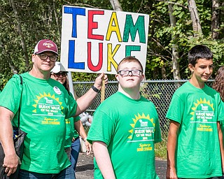 DIANNA OATRIDGE | THE VINDICATOR Lucas Neer (center), 17, of Deerfield walks with his dad, Ed Neer (left), and friend Nathan Darney (right) 15, of Lake Milton, at the Down Syndrome Association's  Buddy Walk of the Valley at Eastwood Field in Niles on Sunday.