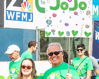 DIANNA OATRIDGE | THE VINDICATOR Fred Stoner (right) displays the Team JoJo sign to support his daughter JoJo Stoner (left) at the Down Syndrome Association's Buddy Walk of the Valley at Eastwood Field in Niles on Sunday.