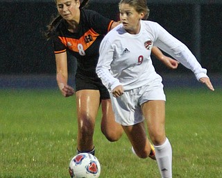 William D. Lewis The Vindicator   Canfield's Morgan Carey(9) and Howland's Olivia Myers(8) during 9-24-18 action at Howland.