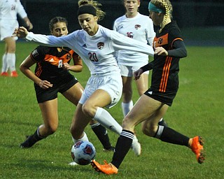 William D. Lewis The Vindicator   Canfield's Camryn Kohut(20) moves the ball past and Howland's Olivia Myersd (8) and Erica Merkel(1) during 9-24-18 action at Howland.