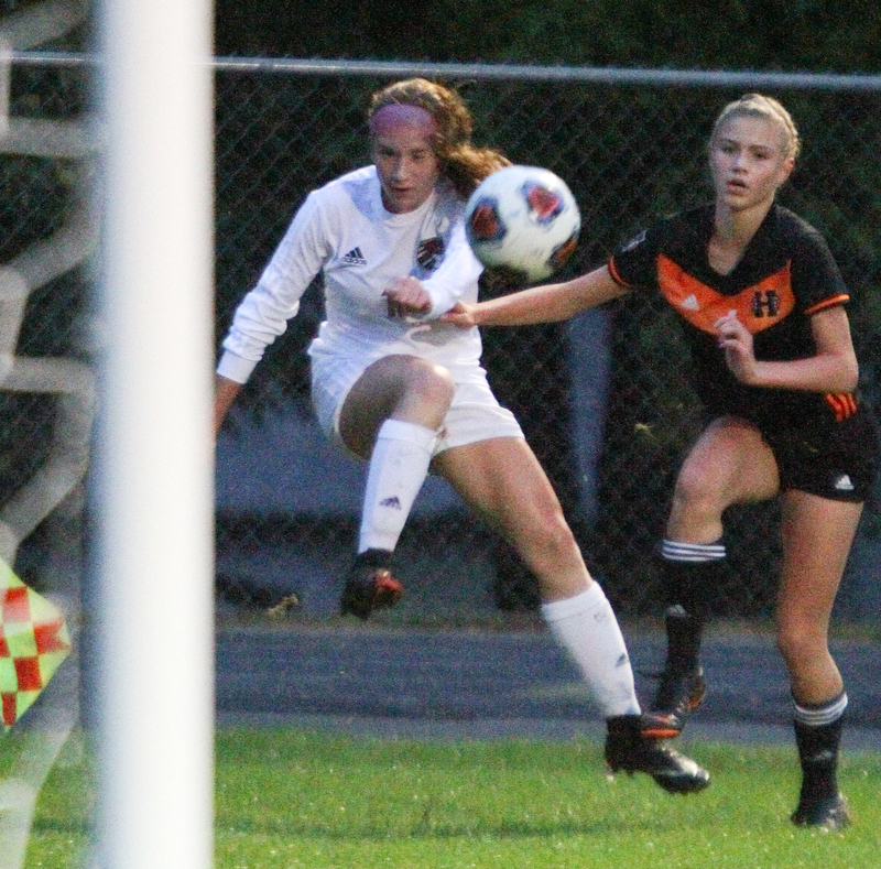 William D. Lewis The Vindicator   Canfield'sEllie Accordino(16) and Howland's Malina Andamasaris(6) during 9-24-18 action at Howland.