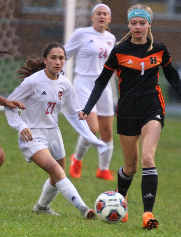 William D. Lewis The Vindicator   Canfield's Marissa Ieraci(21) and Howland's Erica Merkel(1) during 9-24-18 action at Howland.