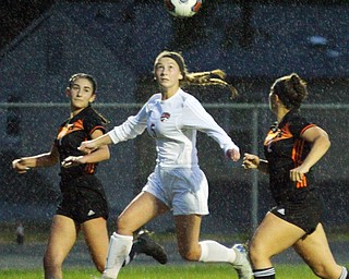 William D. Lewis The Vindicator   Canfield's Marisa Scheetz(5) and Howland's Leah Lerakis(70 andGianna Merlo(2) during 9-24-18 action at Howland.