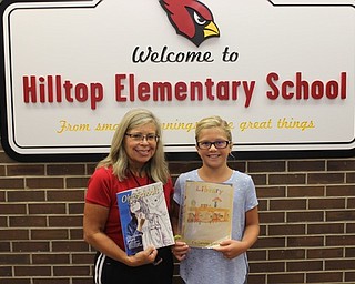 Neighbors | Abby Slanker.Hilltop Elementary School third-grade student Eva Camuso (right) was named a winner in the “Ohio Schools” magazine Create a Cover Contest with the help of Hilltop Elementary School physical education teacher Linda Magyar (left) who submitted Camuso’s drawing to the contest.