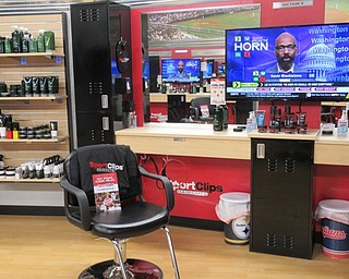 Neighbors | Jessica Harker .An empty seat sat ready for customers at the newly opened Sports Clip on Mahoning Avenue in Austintown.