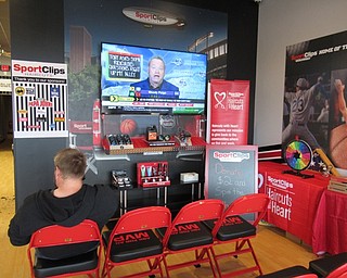 Neighbors | Jessica Harker .The waiting area for the new Sports Clips in Austintown on Sept. 11 features a large flat screen TV always tuned to sports programs.