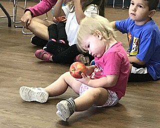 Neighbors | Jessica Harker.Camryn Porter, age 2, examined her apple on Sept. 13 at the MetroParks Farms where she attended the An Apple a Day event.