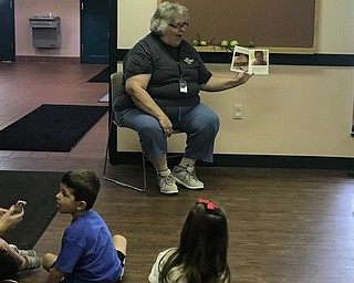 Neighbors | Jessica Harker.Brenda Markley, a MillCreek park naturalist, read "Apples of Your Eye," to the children gathered at the An Apple a Day event Sept. 13.