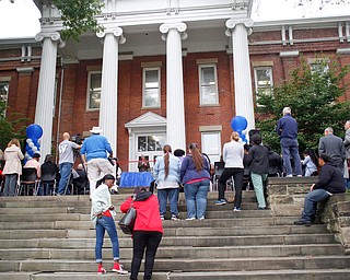 People surround the new Youngstown Rayen Early College High School during the ribbon cutting ceremony on Thursday.