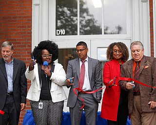 From left, John Wilson, the former principal of Youngstown Early College High School, Monica Jones, the principal of the Youngstown Rayen Early College High School, Krish Mohip, Youngstown Ctiy Schools CEO, Henrietta Williams, with the Rayen Foundation, and Joe Meranto, the superintendent of Youngstown City Schools, cut the ribbon for the new Youngstown Rayen Early College High School on Thursday.