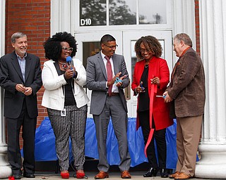 From left, John Wilson, the former principal of Youngstown Early College High School, Monica Jones, the principal of the Youngstown Rayen Early College High School, Krish Mohip, Youngstown Ctiy Schools CEO, Henrietta Williams, with the Rayen Foundation, and Joe Meranto, the superintendent of Youngstown City Schools, cut the ribbon for the new Youngstown Rayen Early College High School on Thursday.