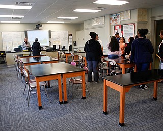 Groups visit Mr. Mark Robinson's classroom during a tour of the new Youngstown Rayen Early College High School on Thursday.