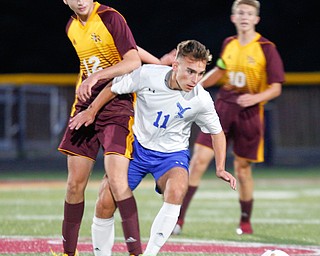 Hubbard's Michael VanSuch (11) and South Range's Luke McConnell (12) go after the ball during the first half of their game at South Range on Thursday. EMILY MATTHEWS | THE VINDICATOR