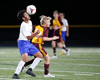 Hubbard's Nader Kassem and South Range's Logan Weaver go after the ball during the first half of their game at South Range on Thursday. EMILY MATTHEWS | THE VINDICATOR