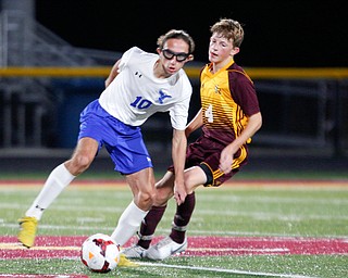 Hubbard's AJ Trobek tries to keep the ball away from South Range's Dakota Bartels during the first half of their game at South Range on Thursday. EMILY MATTHEWS | THE VINDICATOR