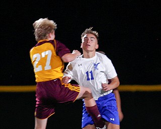 Hubbard's Michael VanSuch and South Range's Logan Weaver go after the ball during the first second of their game at South Range on Thursday. EMILY MATTHEWS | THE VINDICATOR