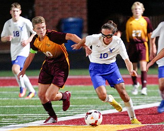 South Range's Canaan Johnson and Hubbard's AJ Trobek go after the ball during the second half of their game at South Range on Thursday. EMILY MATTHEWS | THE VINDICATOR