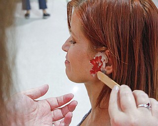  ROBERT K.YOSAY  | THE VINDICATOR..the ladies form  EJFD volunteers   put on makeup . Kelly Jacobs... of newton falls..The Eagle Joint Fire District in conjunction with the Hubbard City Police, Hubbard TWP Police, other area safety forces  including Mercy Health Hospitals and Trumbull Memorial Hospital, St. PatrickÕs Parish Center in Hubbard, Ohio...