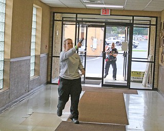  ROBERT K.YOSAY  | THE VINDICATOR.. - Officer Taylor Beshara shoots as officer DJ Dripps over her shoulder...The Eagle Joint Fire District in conjunction with the Hubbard City Police, Hubbard TWP Police, other area safety forces  including Mercy Health Hospitals and Trumbull Memorial Hospital, St. PatrickÕs Parish Center in Hubbard, Ohio...
