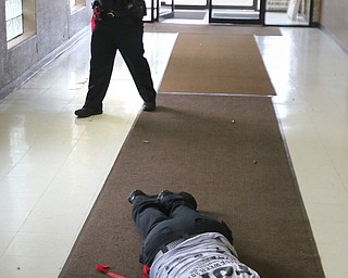  ROBERT K.YOSAY  | THE VINDICATOR.. Taken DOWN - Officer Taylor Beshara lies on the floor  as officer DJ Dripps over her shoulder...The Eagle Joint Fire District in conjunction with the Hubbard City Police, Hubbard TWP Police, other area safety forces  including Mercy Health Hospitals and Trumbull Memorial Hospital, St. PatrickÕs Parish Center in Hubbard, Ohio...