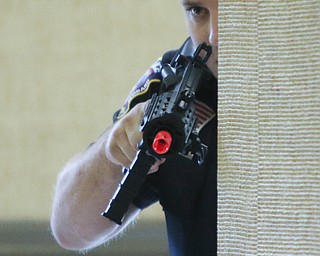  ROBERT K.YOSAY  | THE VINDICATOR..Checking the hallway Officer DJ Drips ..   looks down his sights as he checks a hallway .. The Eagle Joint Fire District in conjunction with the Hubbard City Police, Hubbard TWP Police, other area safety forces  including Mercy Health Hospitals and Trumbull Memorial Hospital, St. PatrickÕs Parish Center in Hubbard, Ohio...