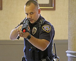  ROBERT K.YOSAY  | THE VINDICATOR..Checking the hallway Officer DJ Drips ..   looks down his sights as he checks a hallway .. The Eagle Joint Fire District in conjunction with the Hubbard City Police, Hubbard TWP Police, other area safety forces  including Mercy Health Hospitals and Trumbull Memorial Hospital, St. PatrickÕs Parish Center in Hubbard, Ohio...