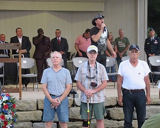 Neighbors | Jessica Harker .Before the opening ceremony of the Ohio Flags of Honor memorial at Boardman Park, performer Ricky Lee brought Vietnam service members up to the stage for a tribute song.