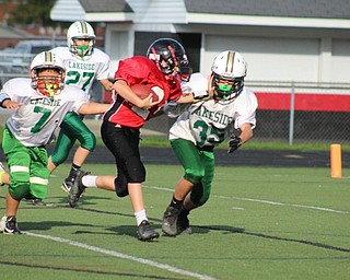 Neighbors | Submitted.Tyler Eikart, Canfield Village Middle School seventh-grade football player, is pictured running the ball against players from Ashtabula Lakeside.