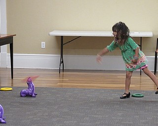 Neighbors | Jessica Harker.Maryan Wibowo played a ring toss game at the Poland library's Back to School Bash event Sept. 17.