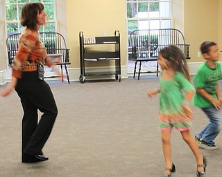Neighbors | Jessica Harker.Librarian Hayley McEwing danced with Maryan and Drixson Wibowo Sept. 17 at the Poland library's Back to School Bash.