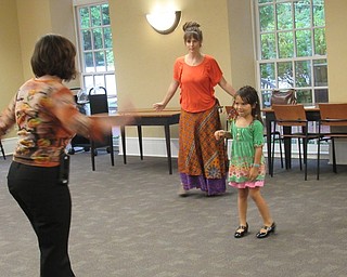 Neighbors | Jessica Harker.Hayley McEwing, a librarian at the Poland library, set up a dance party during the Back to School Bash Sept. 17 where Maryan Wibowo and her mom participated in.