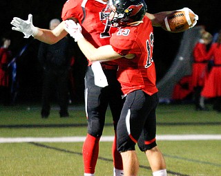 Canfield's Matt Zaremski (7) and Richie Herrera celebrate during the first half of their game against Boardman at Canfield on Friday. EMILY MATTHEWS | THE VINDICATOR