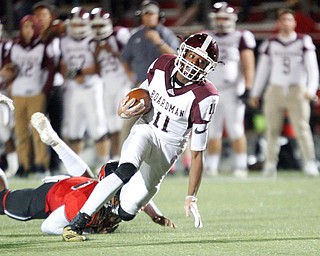 Boardman's Che Trevena tries to get past Canfield's Mehlyn Clinkscale during the first half of their game at Canfield on Friday. EMILY MATTHEWS | THE VINDICATOR