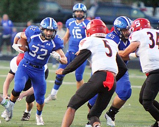 William D. Lewis The Vindicator Poland's Jake Rutana(32) eludes Struthers' Tyrese Hawkins(5) during 9-28-18 action at Poland.