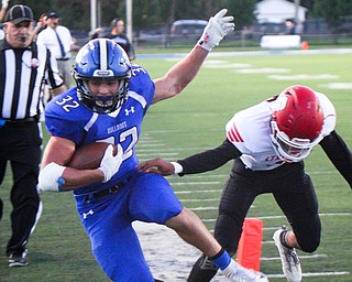 William D. Lewis The Vindicator Poland's Jake Rutana(32) eludes Struthers' Tyrese Hawkins(5) to score during 1rst qtr of 9-28-18 action at Poland.