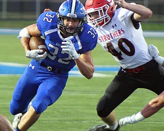 William D. Lewis The Vindicator Poland's Jake Rutana(32) eludes Struthers' Joseph Macciomie(40) during 9-28-18 action at Poland.