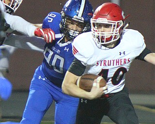 William D. Lewis The Vindicator Struthers Joseph Macciomie(40) eludes Poland's Scott Campbell(90)during 9-28-18 action at Poland.