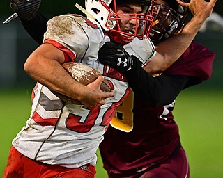 LIBERTY, OHIO - SEPTEMBER 28, 2018: LaBrae's Colton Stoneman fights off a tackle by Liberty's Jaime Melton during the first half of their game, Friday night at Liberty High School. DAVID DERMER | THE VINDICATOR